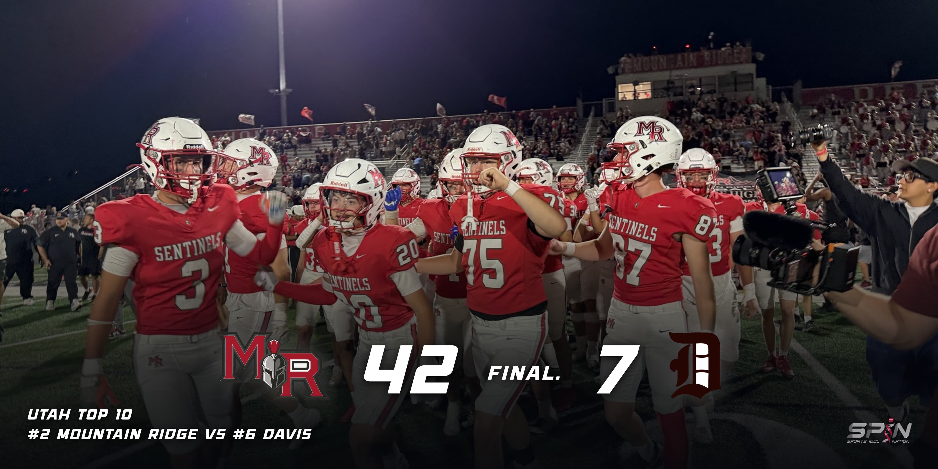 Mountain Ridge players in red Sentinels jerseys and white MR helmets walk off the field celebrating after beating Davis, with a full student section and the Mountain Ridge press box lit behind them and a television camera at the right. Across the bottom the Mountain Ridge and Davis school marks flank the score, which reads 42, FINAL, 7, above a line reading Utah Top 10, number 2 Mountain Ridge vs number 6 Davis, with the SPIN Sports Idol Nation mark at bottom right.