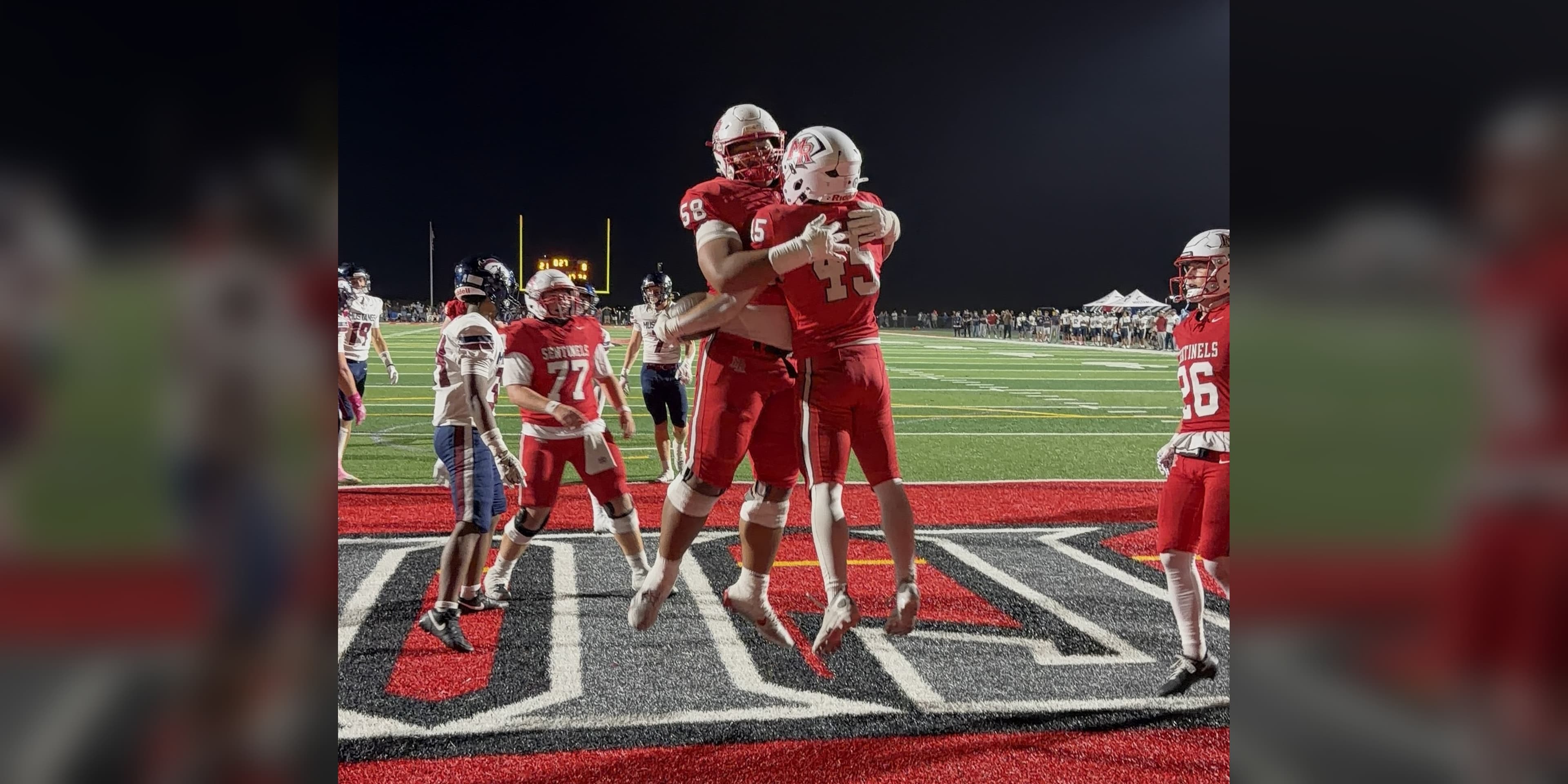 Mountain Ridge running back Tyson Dunn, No. 45, celebrates a touchdown with a teammate in the end zone against Herriman on Friday, October 2, 2026, in Herriman, Utah.